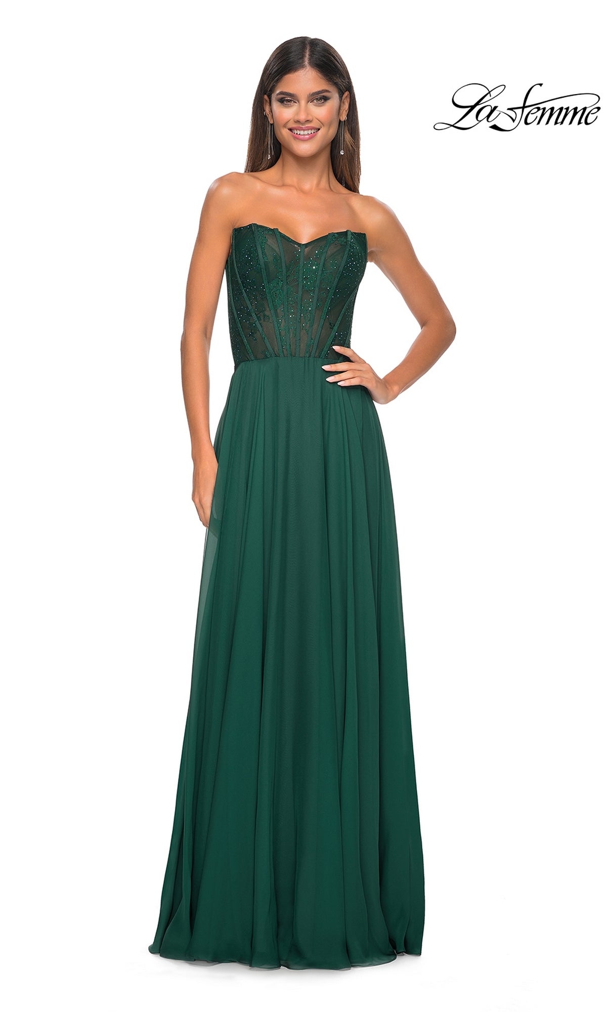 A woman stands and smiles against a white background in the La Femme Lace-Bodice Long A-Line Prom Dress 32311, featuring a strapless dark green design with a semi-sheer embellished bodice.